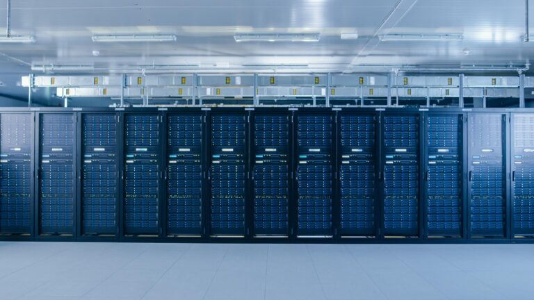 Working Data Center With Rows of Rack Servers. Led Lights Blinking and Computers are Working