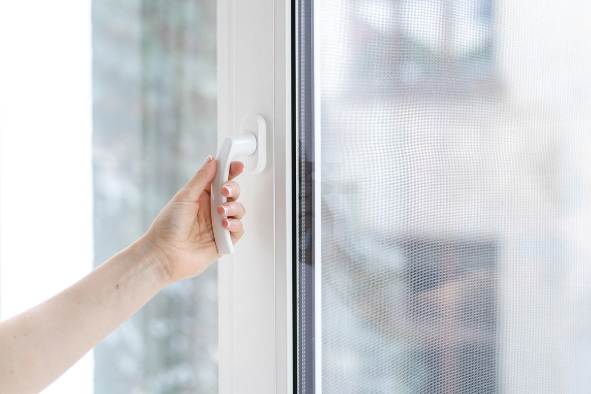 Hand closing a window
